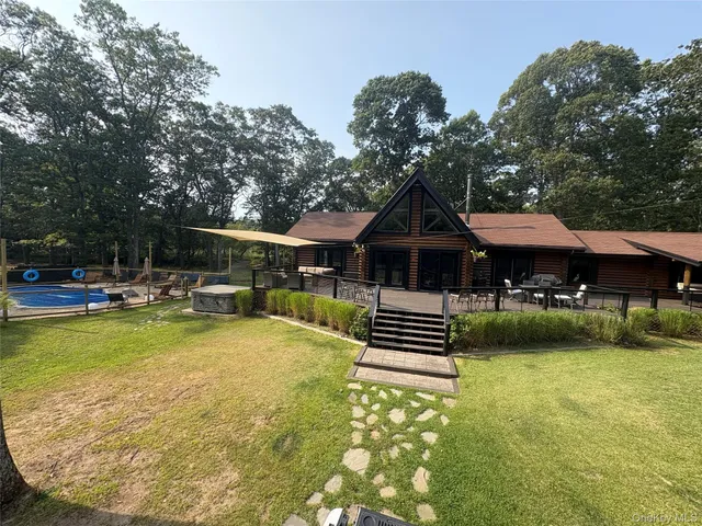 swimming pool view with a seating space