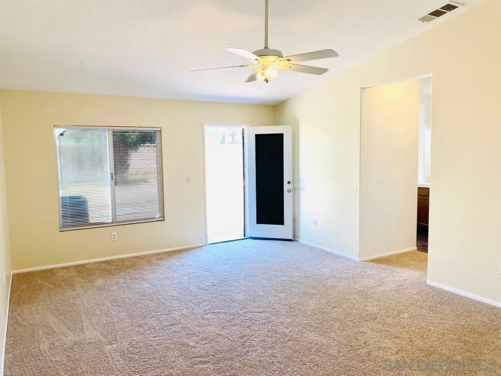 914 Aria Road Hemet, CA 92543 - Photo 11 of 27 a view of an empty room with chandelier fan and fire place