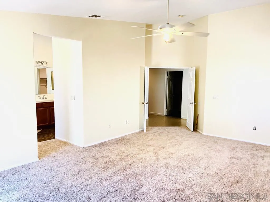 914 Aria Road Hemet, CA 92543 - Photo 12 of 27 a view of a room with a chandelier fan and kitchen view