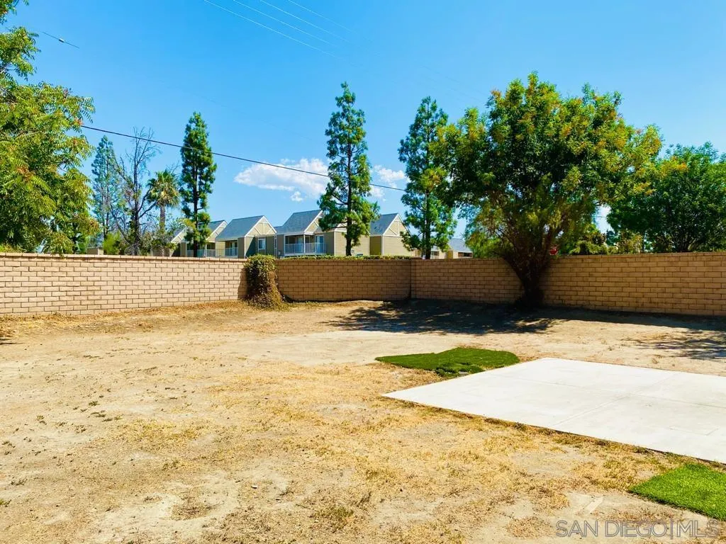 914 Aria Road Hemet, CA 92543 - Photo 24 of 27 a street view with wooden fence