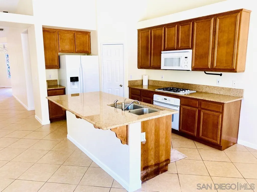 914 Aria Road Hemet, CA 92543 - Photo 3 of 27 a kitchen with stainless steel appliances granite countertop a stove a sink and a microwave