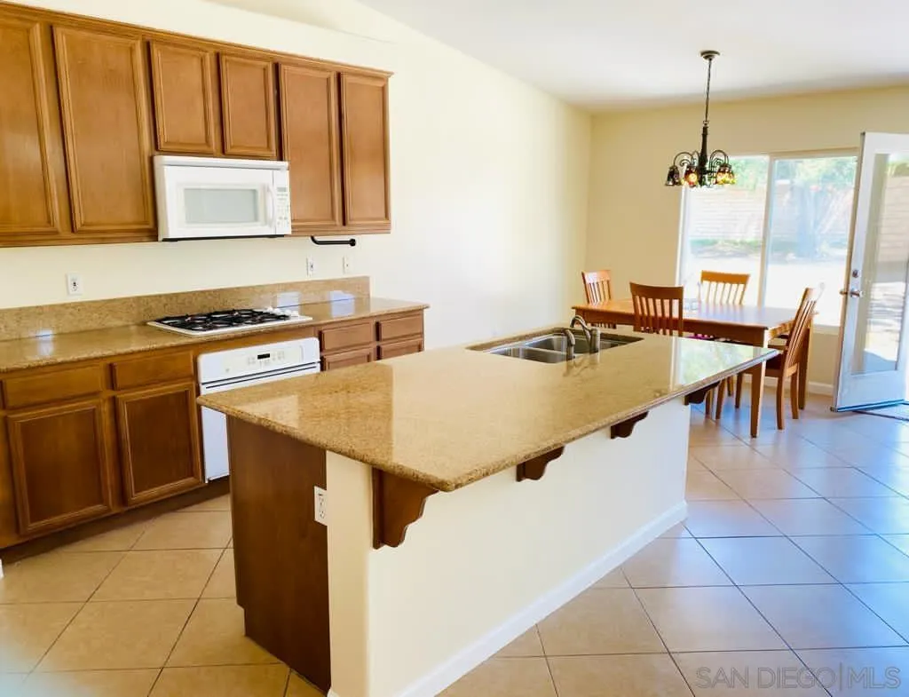 914 Aria Road Hemet, CA 92543 - Photo 6 of 27 a kitchen with stainless steel appliances granite countertop a stove top oven a sink dishwasher and cabinets with wooden floor