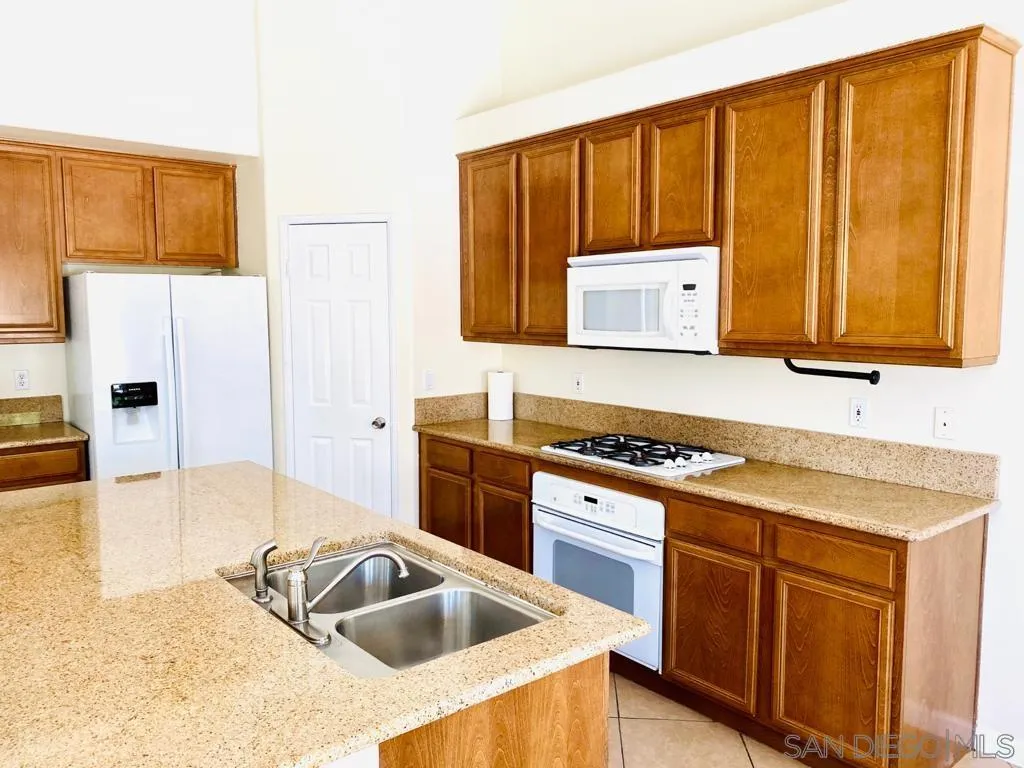 914 Aria Road Hemet, CA 92543 - Photo 8 of 27 a kitchen with a sink cabinets and stainless steel appliances