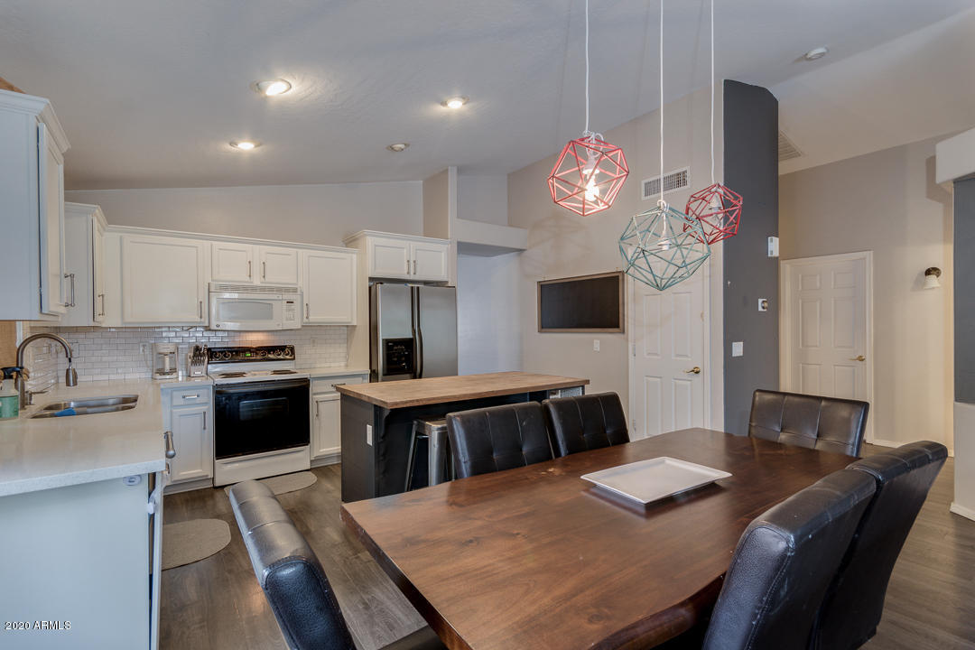 3339 East Bonanza Road Gilbert, AZ 85297 - Photo 13 of 47 a large kitchen with a table and chairs