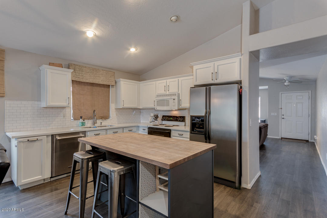 3339 East Bonanza Road Gilbert, AZ 85297 - Photo 15 of 47 a kitchen with a stove a refrigerator and a sink