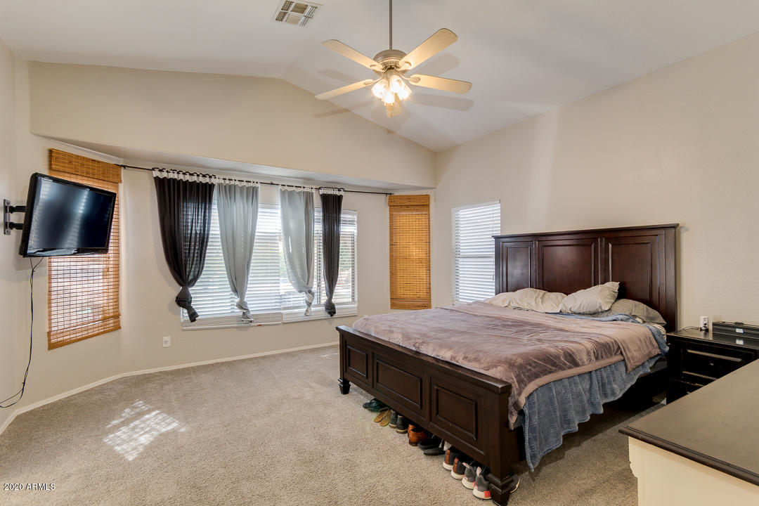 3339 East Bonanza Road Gilbert, AZ 85297 - Photo 19 of 47 a bedroom with a bed a window and mirror
