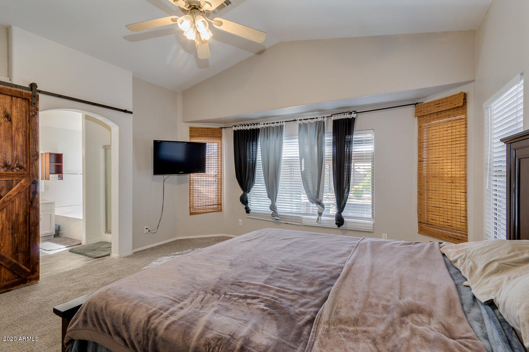 3339 East Bonanza Road Gilbert, AZ 85297 - Photo 22 of 47 a bedroom with a bed and a flat screen tv