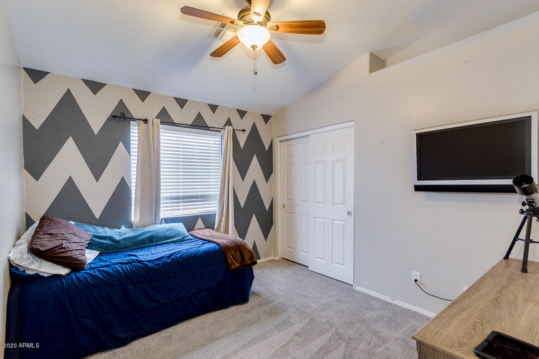 3339 East Bonanza Road Gilbert, AZ 85297 - Photo 26 of 47 a bedroom with a bed and a flat tv screen on the dresser