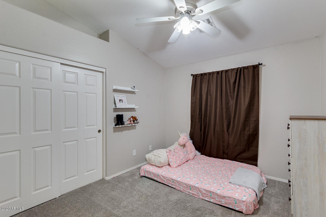 3339 East Bonanza Road Gilbert, AZ 85297 - Photo 29 of 47 a bedroom with a bed and a chandelier