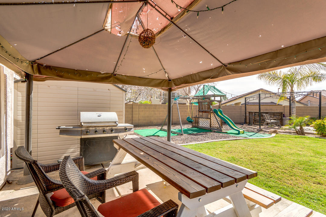 3339 East Bonanza Road Gilbert, AZ 85297 - Photo 34 of 47 a view of a backyard with a patio and outdoor seating