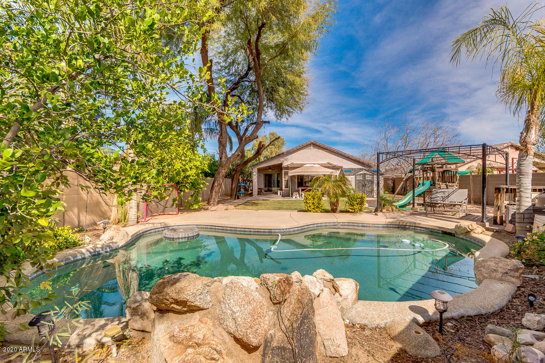 3339 East Bonanza Road Gilbert, AZ 85297 - Photo 40 of 47 a swimming pool with outdoor seating and yard