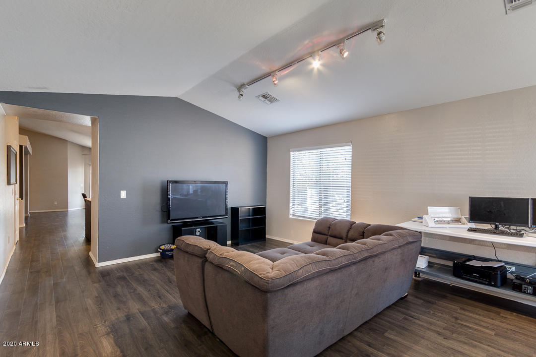 3339 East Bonanza Road Gilbert, AZ 85297 - Photo 4 of 47 a living room with furniture and a flat screen tv