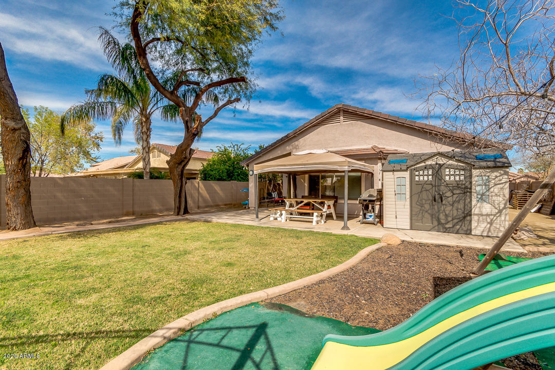 3339 East Bonanza Road Gilbert, AZ 85297 - Photo 44 of 47 a front view of house with yard patio and fire pit