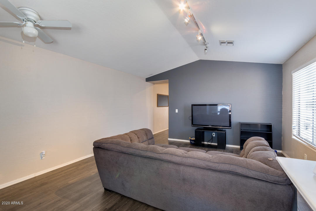 3339 East Bonanza Road Gilbert, AZ 85297 - Photo 5 of 47 a living room with furniture and a flat screen tv