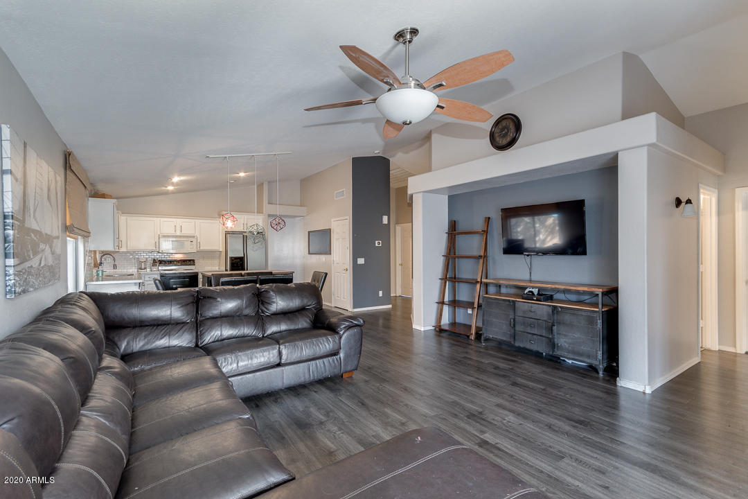 3339 East Bonanza Road Gilbert, AZ 85297 - Photo 8 of 47 a living room with furniture and a flat screen tv
