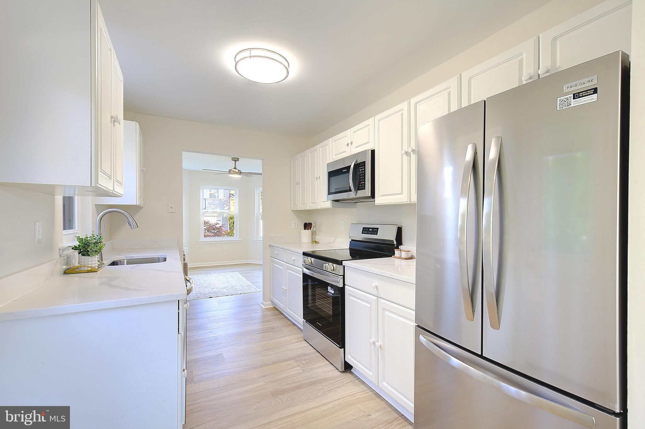 8714 C Street Chesapeake Beach, MD 20732 - Photo 18 of 66 a kitchen with stainless steel appliances a refrigerator sink and microwave