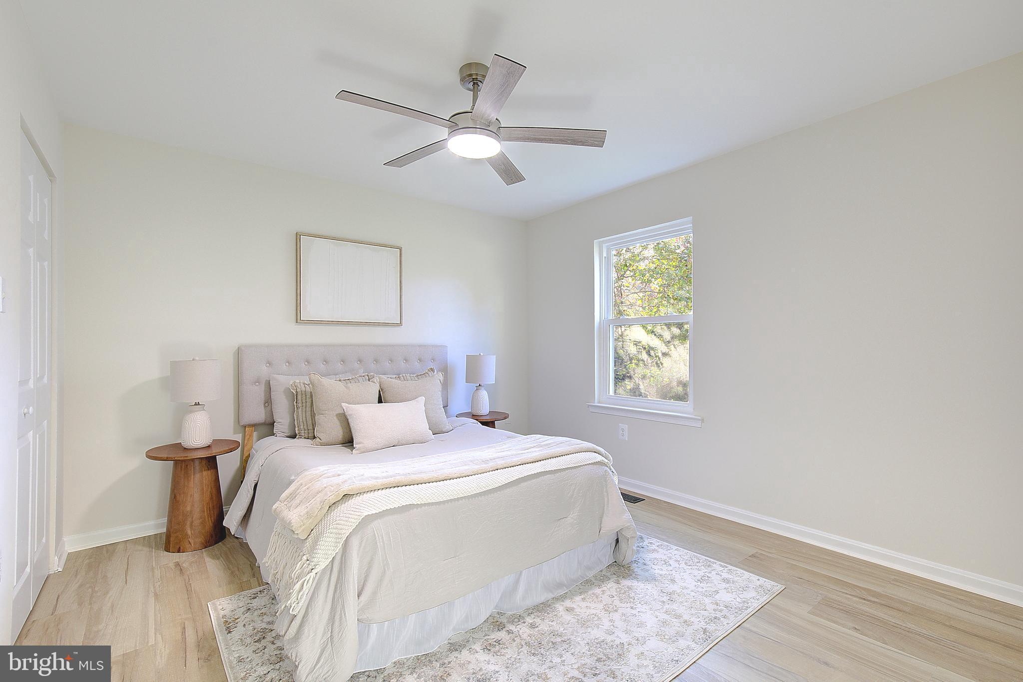 8714 C Street Chesapeake Beach, MD 20732 - Photo 25 of 66 a bedroom with a large bed and a window