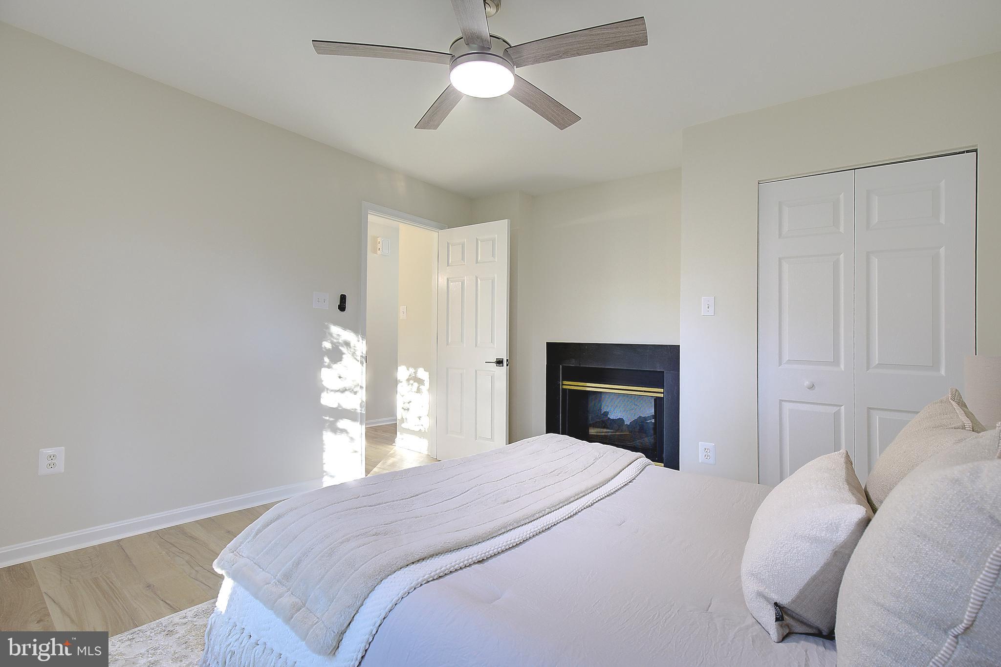 8714 C Street Chesapeake Beach, MD 20732 - Photo 27 of 66 a bedroom with a bed and a chandelier