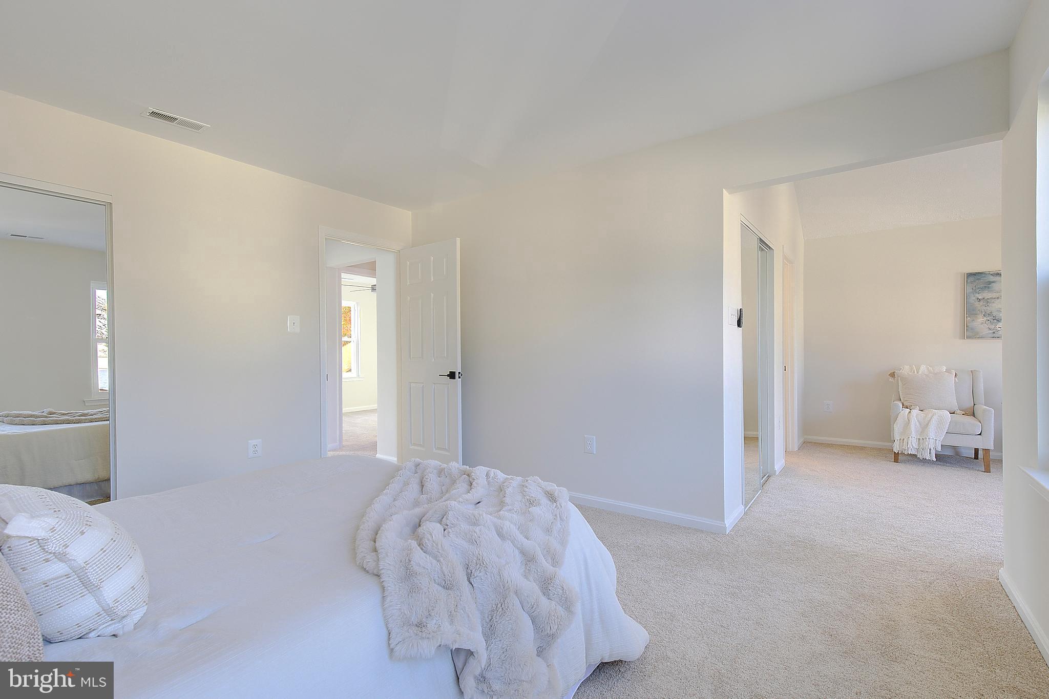 8714 C Street Chesapeake Beach, MD 20732 - Photo 31 of 66 a bedroom with a bed and a lamp