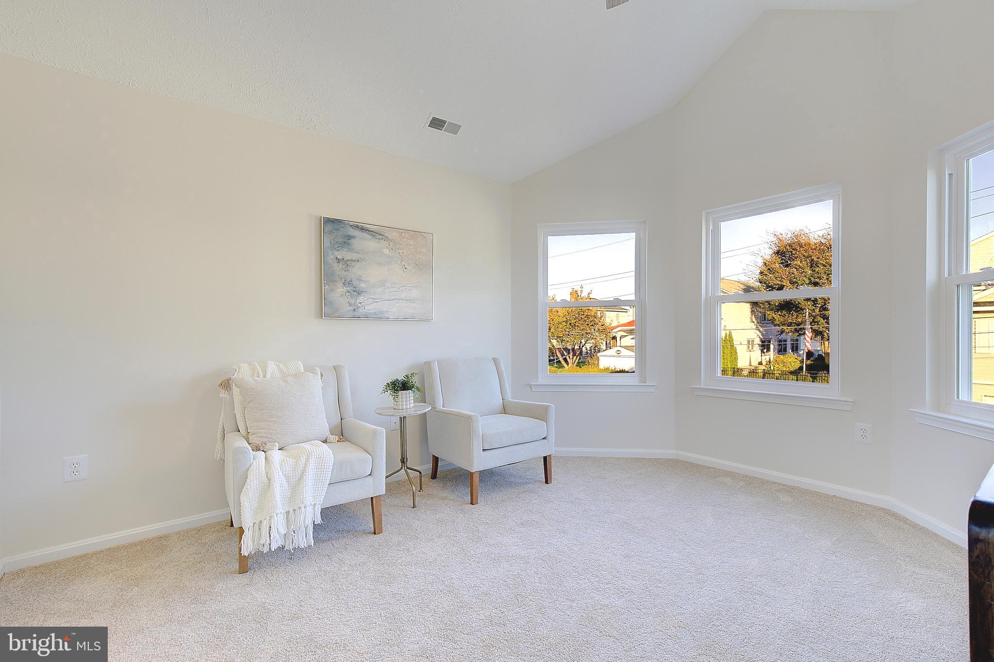 8714 C Street Chesapeake Beach, MD 20732 - Photo 32 of 66 a living room with furniture and a large window