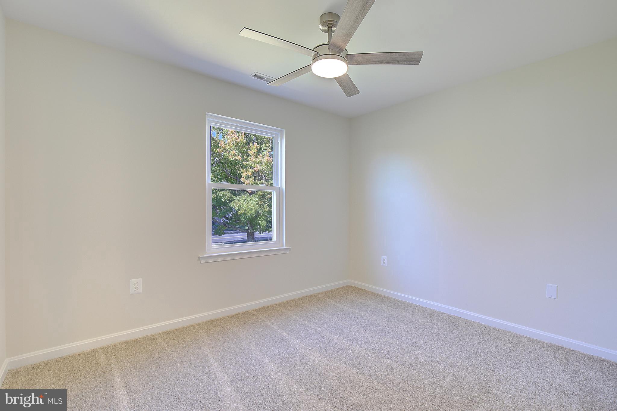 8714 C Street Chesapeake Beach, MD 20732 - Photo 38 of 66 an empty room with a window and a fan