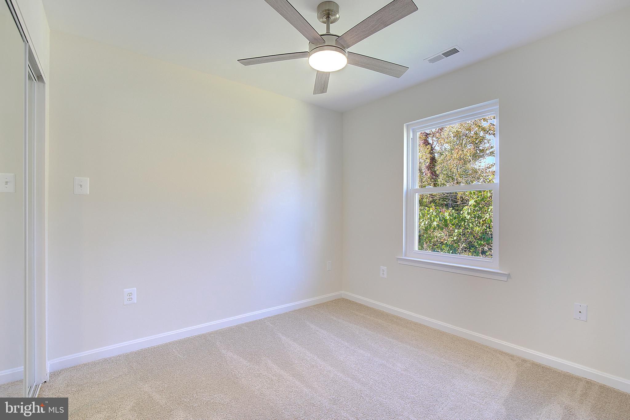 8714 C Street Chesapeake Beach, MD 20732 - Photo 40 of 66 an empty room with a window and a fan