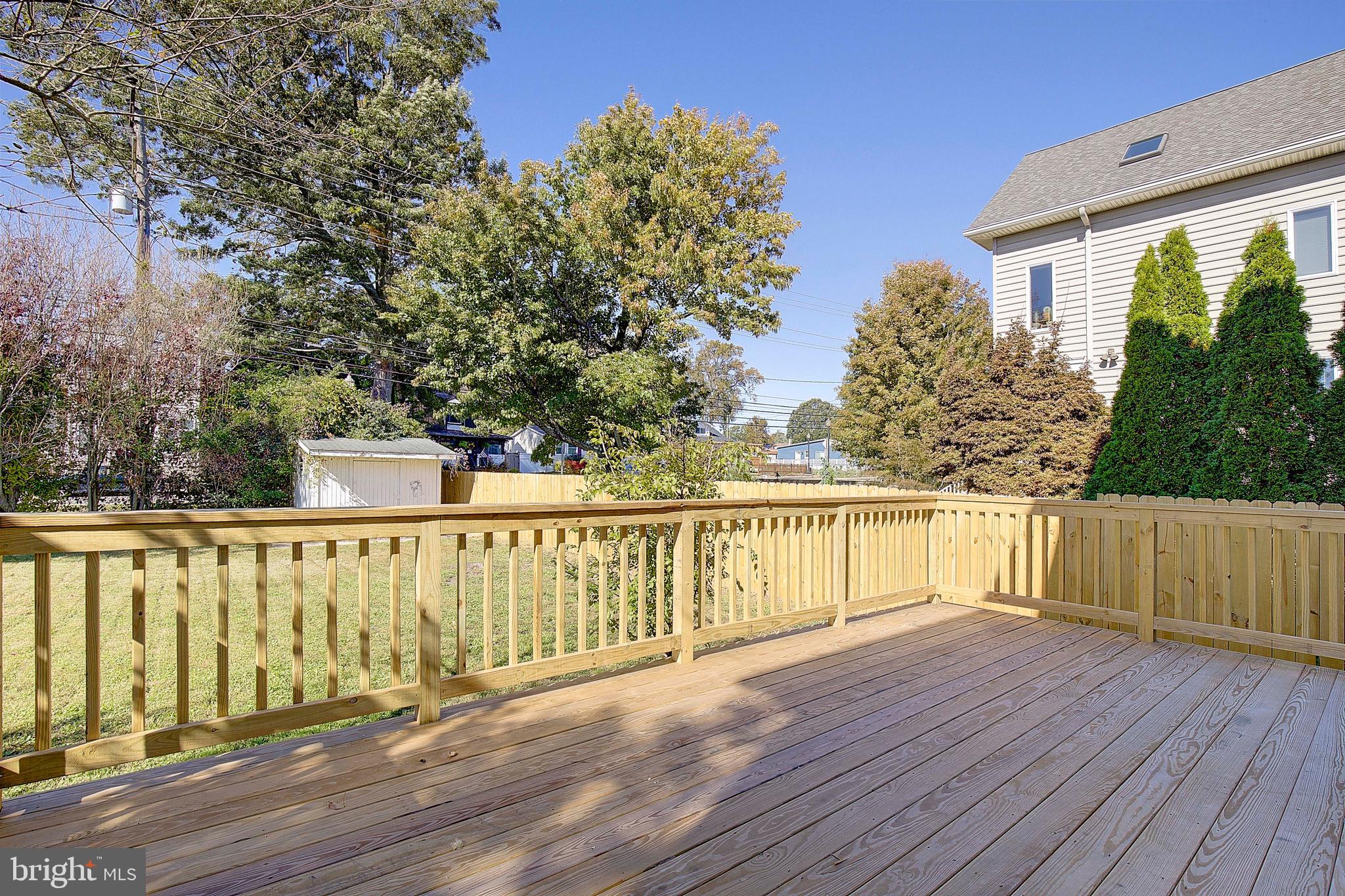 8714 C Street Chesapeake Beach, MD 20732 - Photo 46 of 66 a balcony with wooden floor and fence