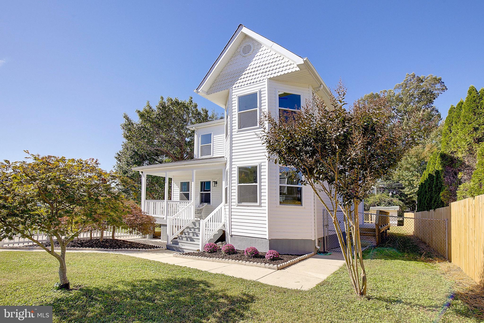 8714 C Street Chesapeake Beach, MD 20732 - Photo 5 of 66 a view of a house with yard and trees in the background