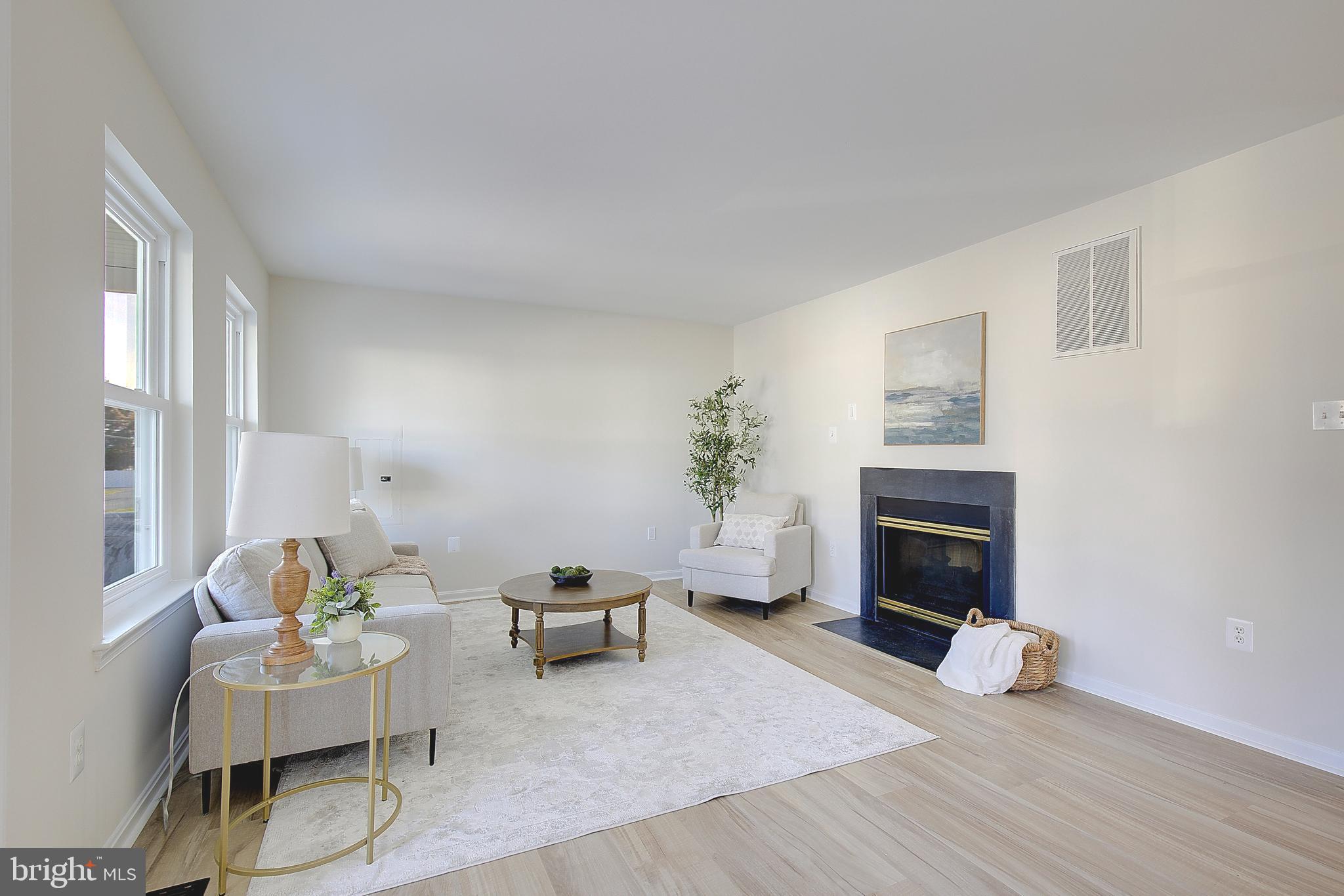 8714 C Street Chesapeake Beach, MD 20732 - Photo 10 of 66 a living room with furniture and a fireplace