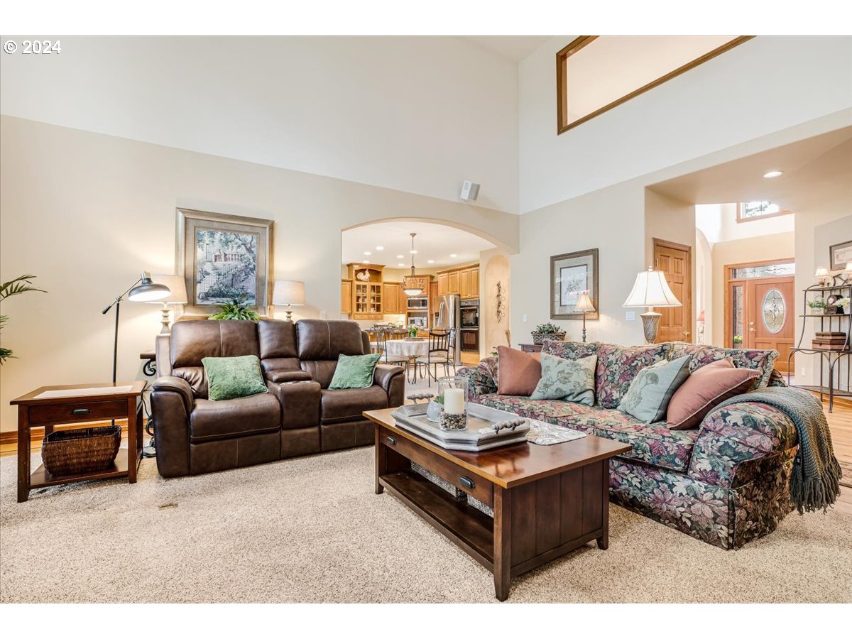 31938 Southeast Dodge Park Boulevard Gresham, OR 97080 - Photo 14 of 48 a living room with furniture a large window and a chandelier