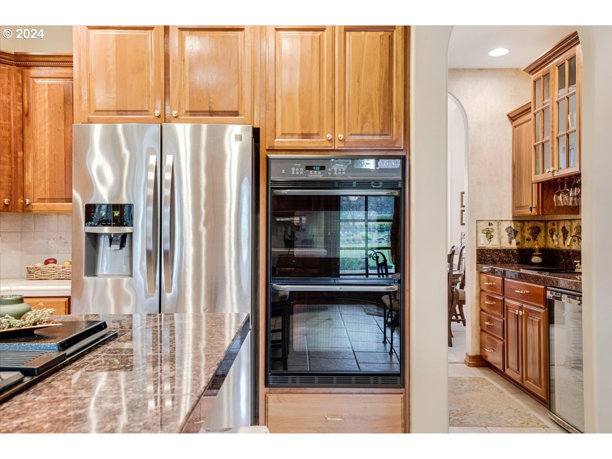 31938 Southeast Dodge Park Boulevard Gresham, OR 97080 - Photo 19 of 48 a kitchen with stainless steel appliances granite countertop a refrigerator and a stove