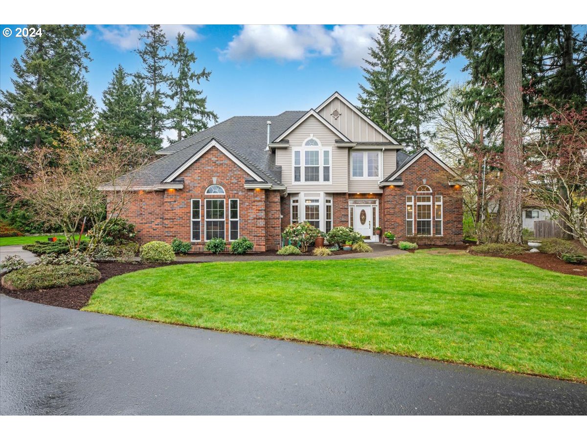 31938 Southeast Dodge Park Boulevard Gresham, OR 97080 - Photo 2 of 48 a front view of a house with a garden