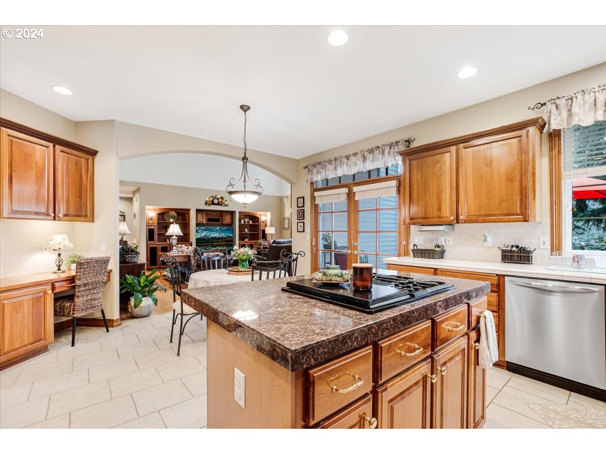 31938 Southeast Dodge Park Boulevard Gresham, OR 97080 - Photo 22 of 48 a kitchen with sink cabinets and dining table