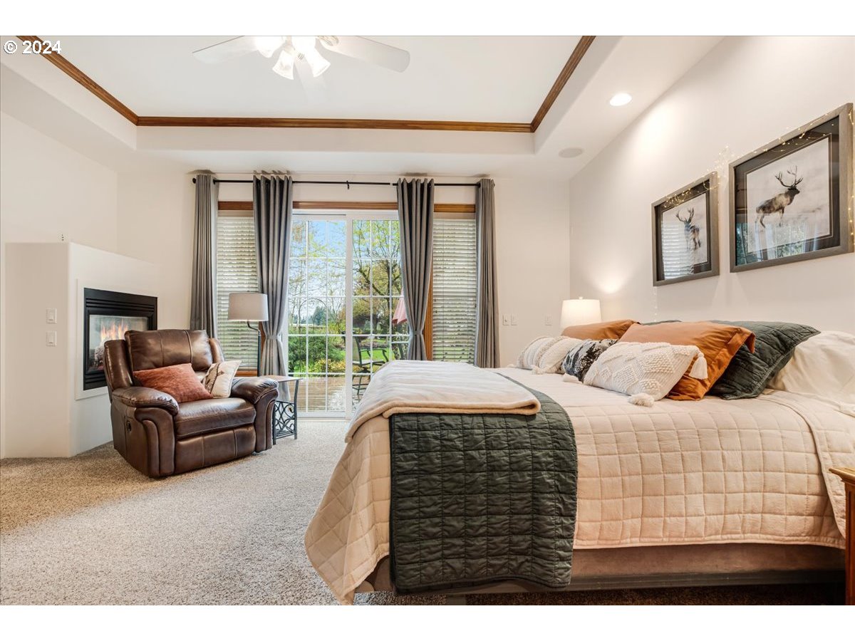 31938 Southeast Dodge Park Boulevard Gresham, OR 97080 - Photo 25 of 48 a bedroom with a bed a couch and a large window