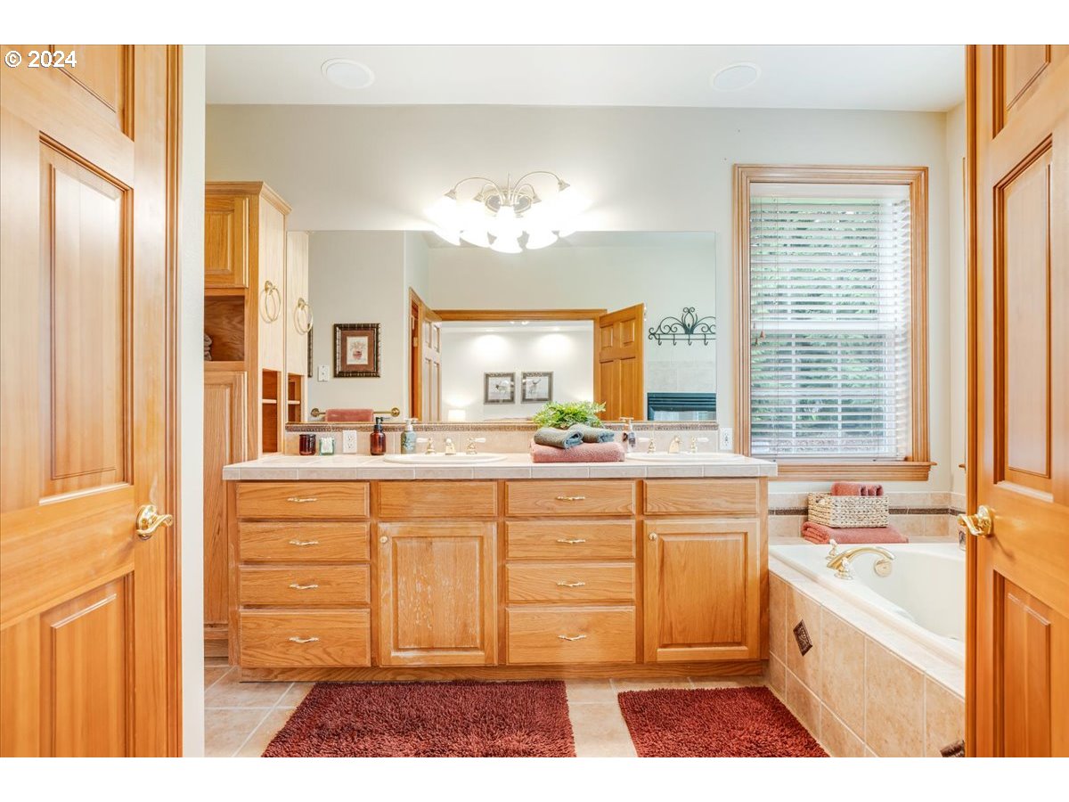 31938 Southeast Dodge Park Boulevard Gresham, OR 97080 - Photo 27 of 48 a bathroom with a tub a sink and a large window