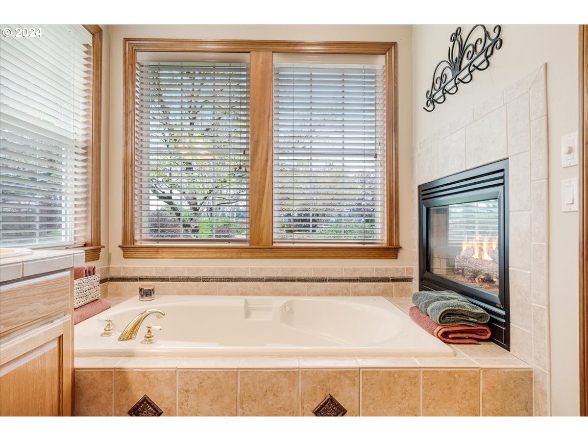 31938 Southeast Dodge Park Boulevard Gresham, OR 97080 - Photo 28 of 48 a bath tub sitting in a bathroom next to a window