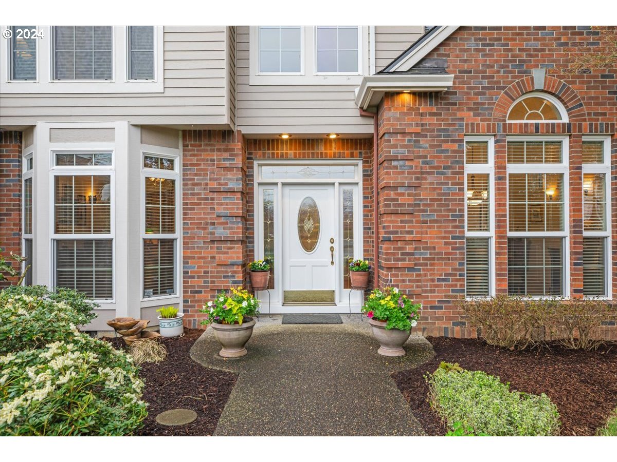 31938 Southeast Dodge Park Boulevard Gresham, OR 97080 - Photo 3 of 48 a front view of a house with a garden
