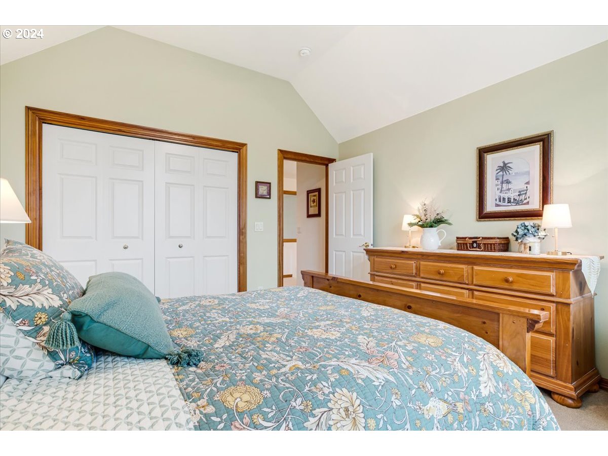 31938 Southeast Dodge Park Boulevard Gresham, OR 97080 - Photo 36 of 48 a bedroom with a bed and a painting on the wall