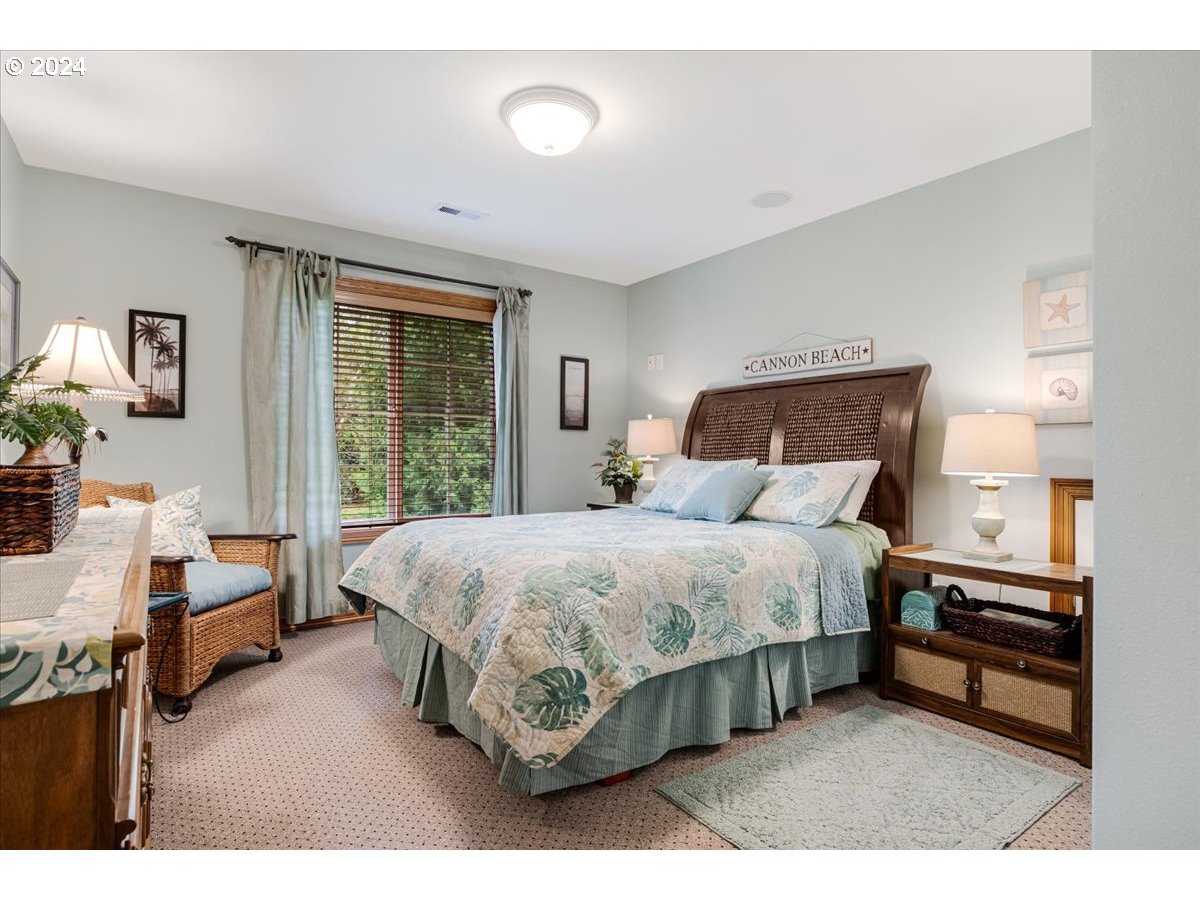 31938 Southeast Dodge Park Boulevard Gresham, OR 97080 - Photo 37 of 48 a bedroom with a bed table and a window