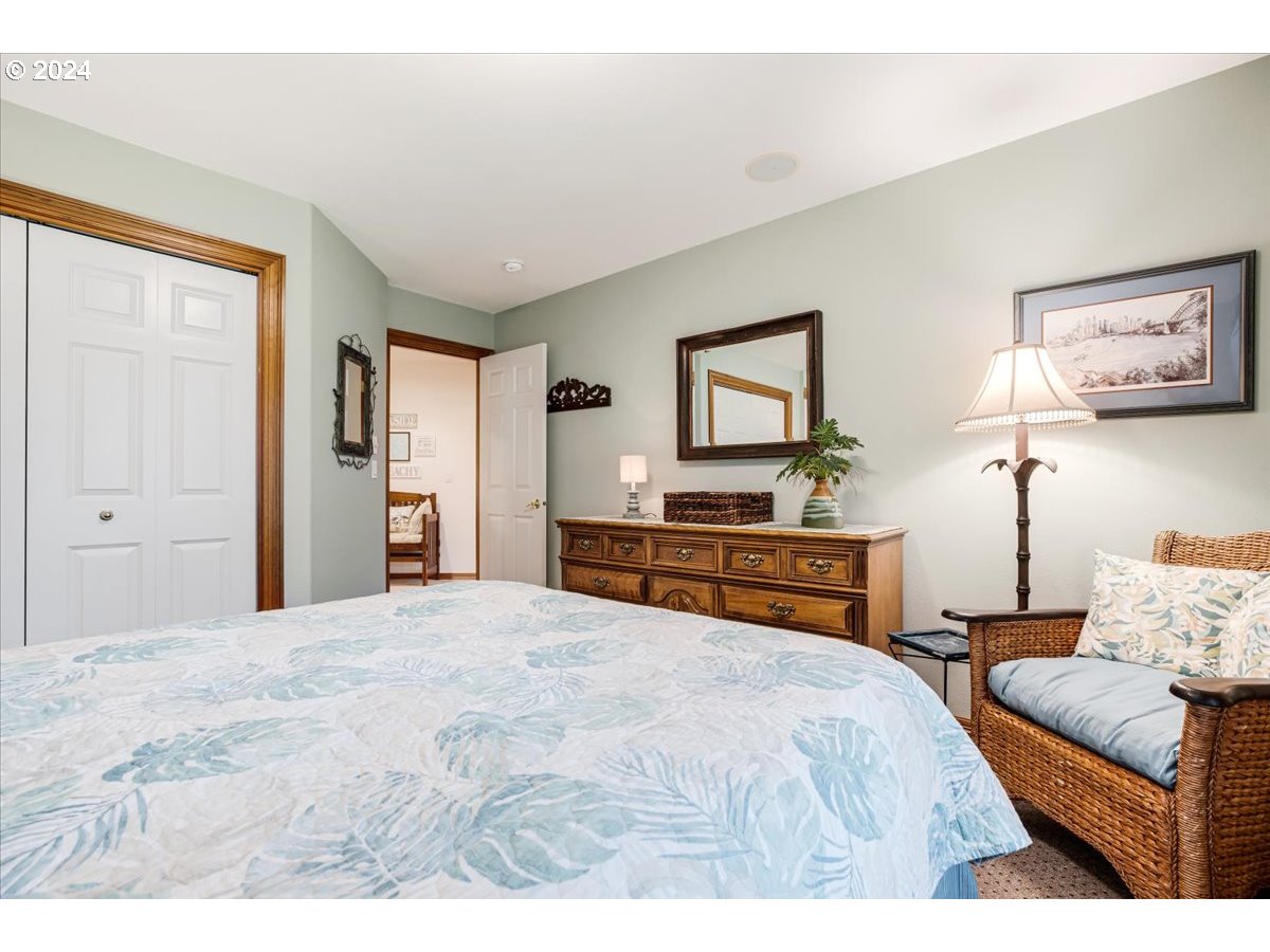 31938 Southeast Dodge Park Boulevard Gresham, OR 97080 - Photo 38 of 48 a bedroom with a large bed and a chandelier