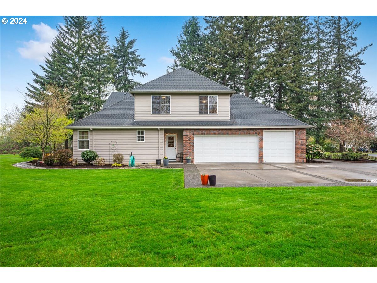31938 Southeast Dodge Park Boulevard Gresham, OR 97080 - Photo 42 of 48 a front view of a house with a yard and garage