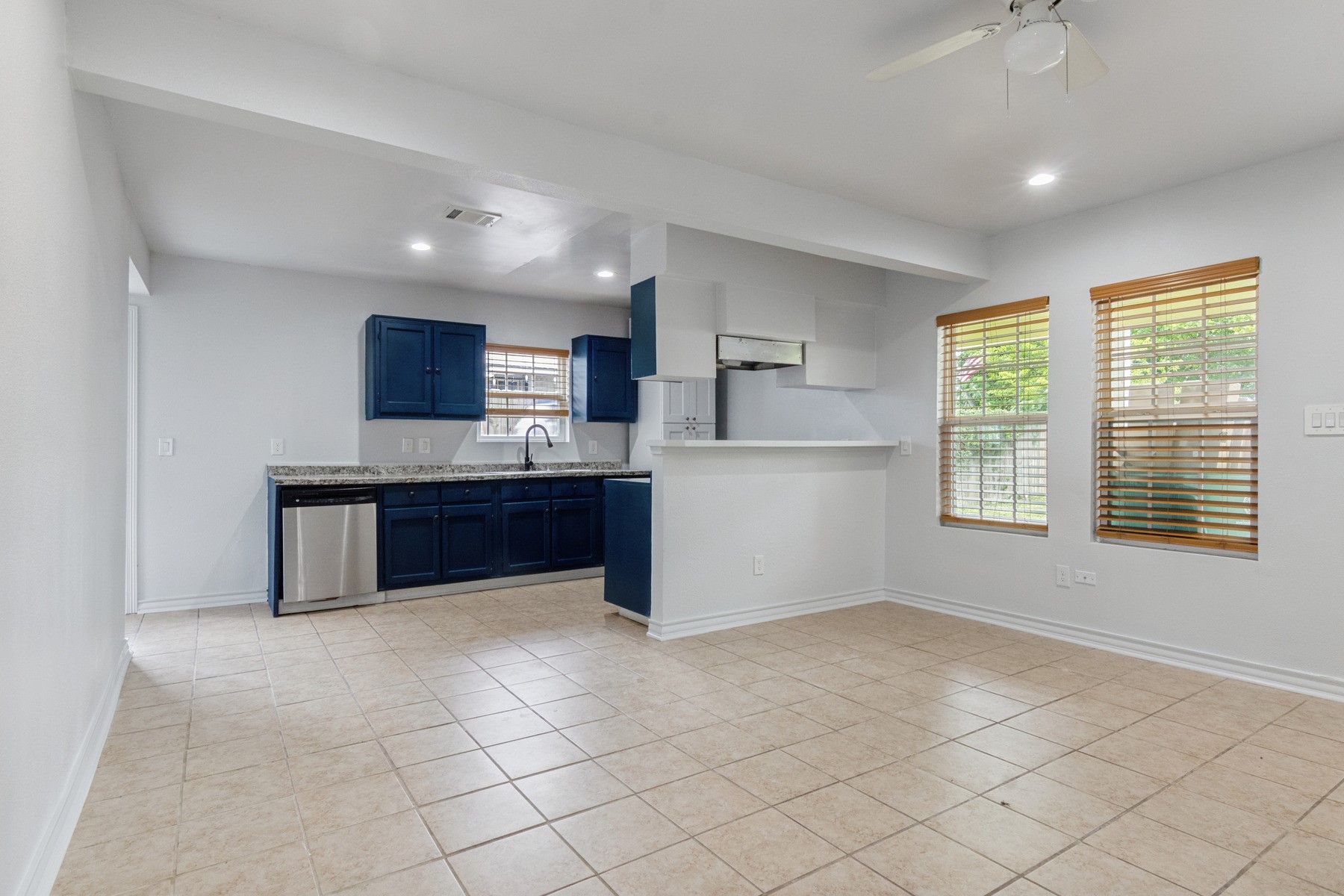 4505 Cochran Street Houston, TX 77009 - Photo 5 of 25 a kitchen with stainless steel appliances a refrigerator and a stove top oven