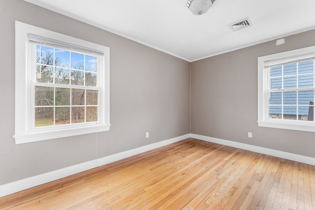 127 Old Millville Road Uxbridge, MA 01569 - Photo 11 of 30 a view of empty room with wooden floor and fan