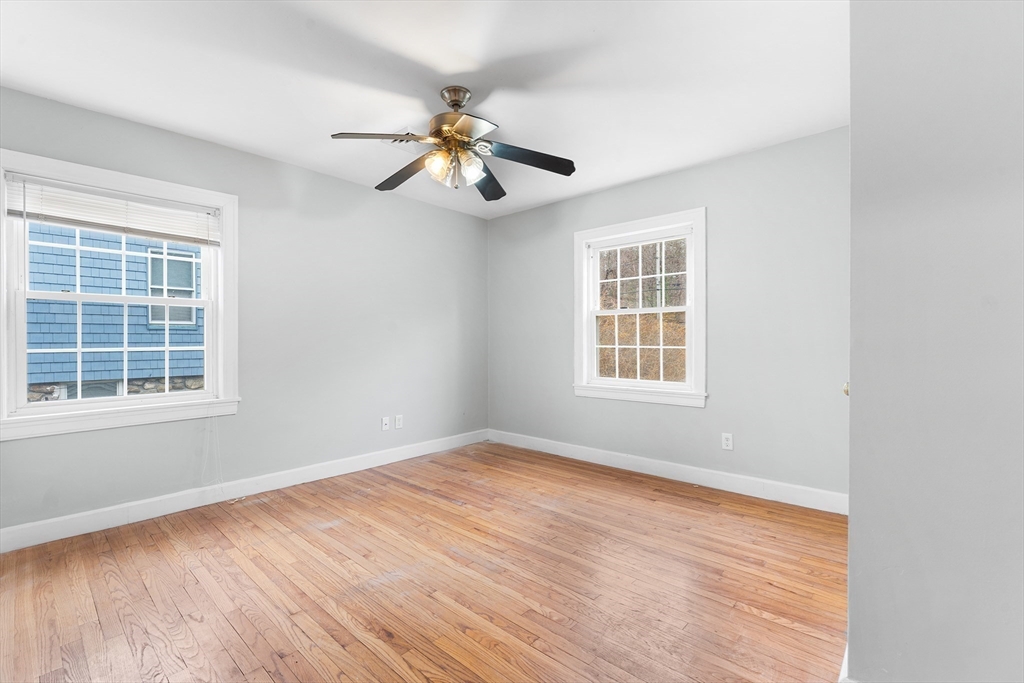 127 Old Millville Road Uxbridge, MA 01569 - Photo 13 of 30 a view of an empty room with wooden floor and a window