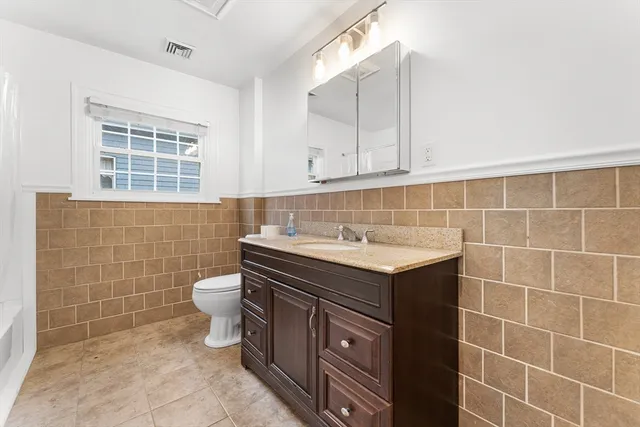 a bathroom with a sink toilet and vanity