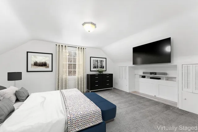 a bedroom with a bed and a flat screen tv