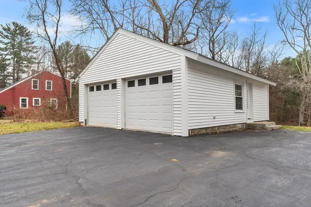 a view of a house with a yard and garage