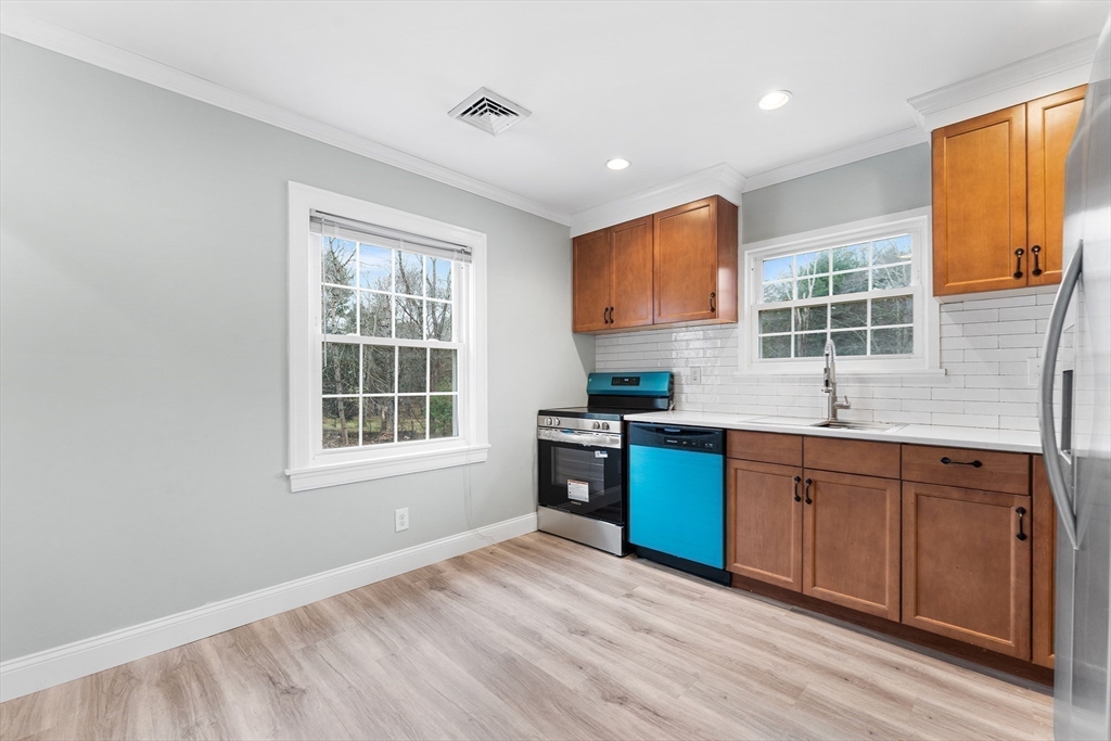 127 Old Millville Road Uxbridge, MA 01569 - Photo 9 of 30 a kitchen with stainless steel appliances granite countertop a stove a sink and a refrigerator