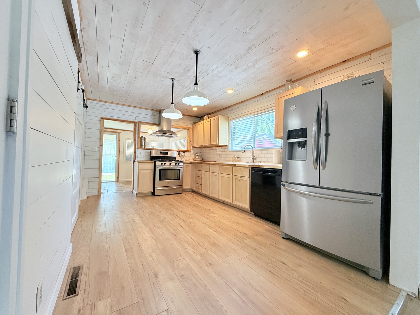90 Pickering Road Harrisburg, IL 62946 - Photo 7 of 15 a kitchen with stainless steel appliances granite countertop a refrigerator a stove top oven a sink dishwasher and a refrigerator with wooden floor