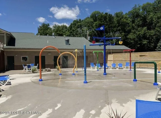 a view of a patio with lawn chairs